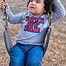 Camille joined the competition — help win amazing prizes! child, toddler, swing, playground, curly_hair, grey_shirt, blue_jeans, outdoor, play, holding, chain, seat, young_child, casual_clothing, expression, person, fun, park, daylight, looking_sideways
