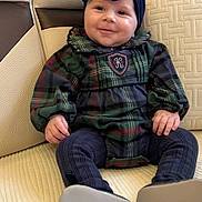 Noa participe au concours pour gagner de l'argent avec cette photo : baby, child, smiling, headband, bow, plaid_dress, sitting, couch, cushion, indoor, portrait, cute, happy, footwear, text_overlay, love, heart_emoji, person, cozy, comfortable