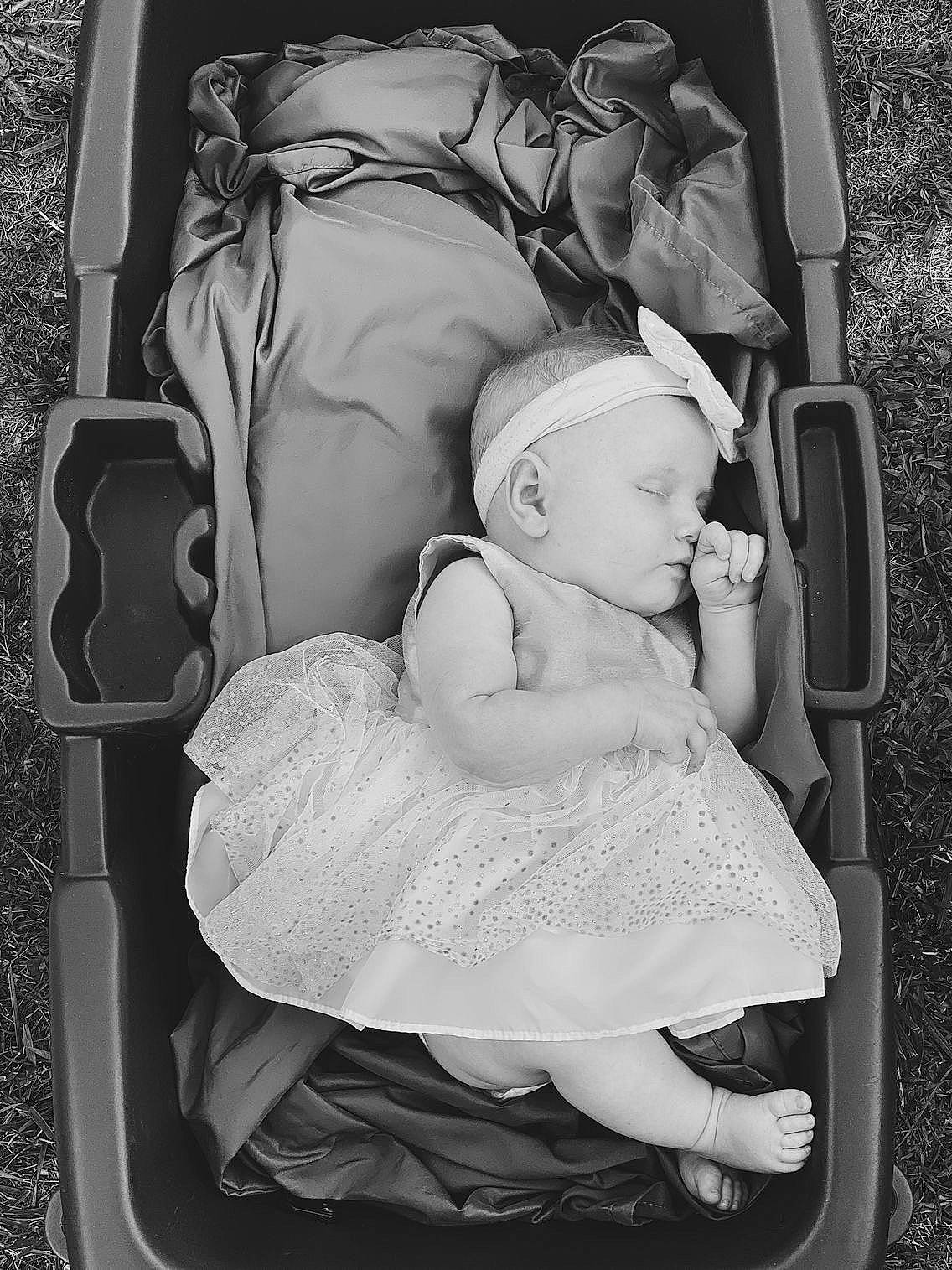 Serena is registered to the contest to win money with this photo: baby, baby_carriage, baby_products, baby_sleeping, black, black_and_white, cheek, child, comfort, facial_expression, flash_photography, hairstyle, hand, interaction, monochrome, monochrome_photography, person, photograph, style, toddler