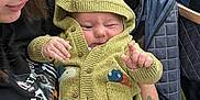 Leon is registered to the contest to win money with this photo: baby, infant, person, hoodie, dinosaur_costume, pacifier, tattoo, blue_hair, outdoor, stroller, leafy_background, cute, smile, winking, clothing, holding, nature, greenery, portrait, casual