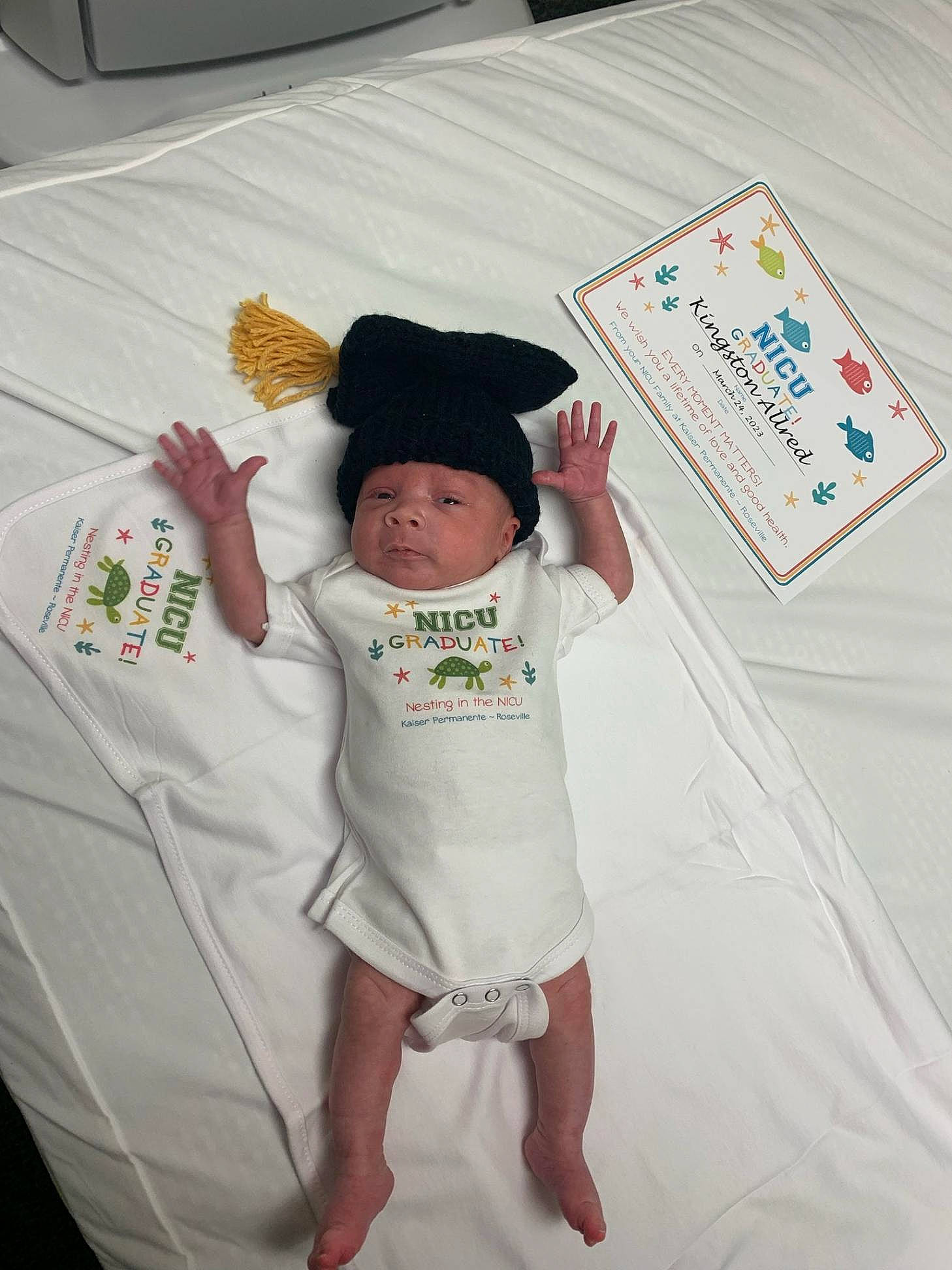 Kingston is registered to the contest to win money with this photo: baby, baby_toddler_clothing, cap, child, elbow, finger, font, fun, gesture, happy, hat, headwear, linens, pattern, person, room, sleeve, t_shirt, thumb, toddler