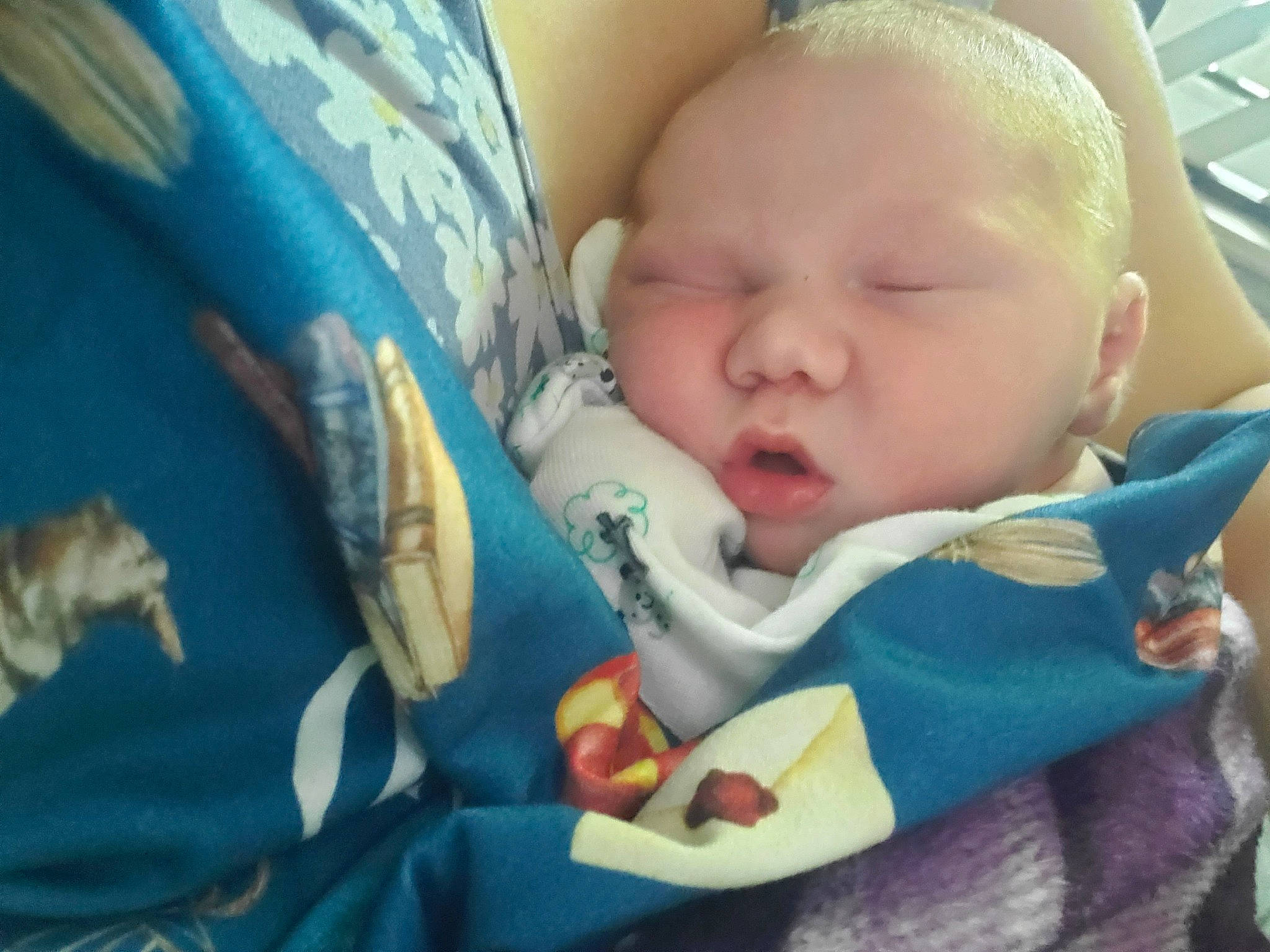 Orion is registered to the contest to win money with this photo: baby, baby_products, baby_sleeping, baby_toddler_clothing, bedding, bedtime, blanket, cheek, child, comfort, grass, happy, linens, mouth, nap, person, room, sleep, textile, toddler