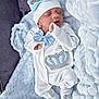 adorable, baby, blue_bow, child, clothing, cozy, crown_design, cute, footwear, hat, indoors, infant, newborn, peaceful, portrait, resting, sleep, sleeping, soft_blanket, white_outfit