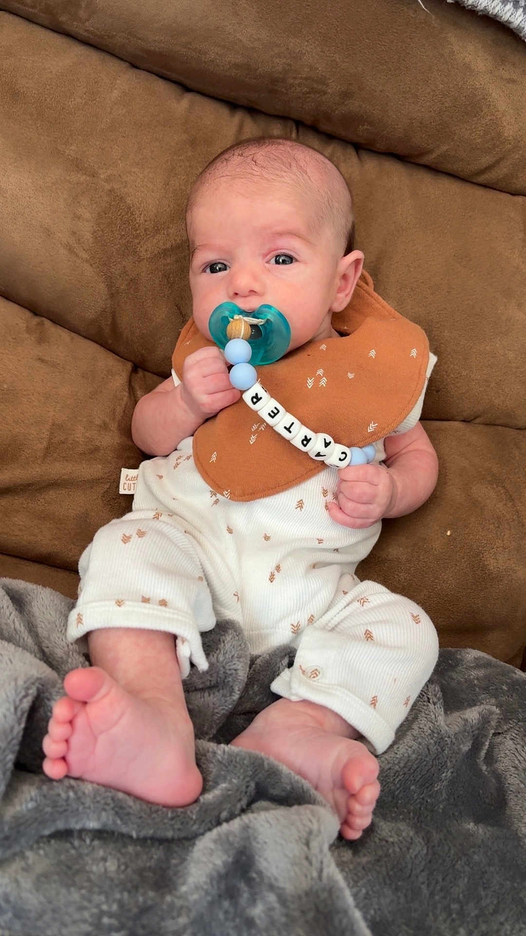 Carter Olin joined the competition — help win amazing prizes! baby, pacifier, bib, couch, blanket, infant, clothing, foot, hand, face, person, indoor, comfort, cute, relaxing, newborn, soft, beads, pattern, portrait