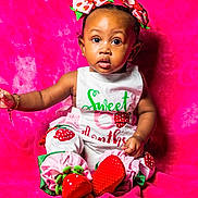 Jade joined the competition — help win amazing prizes! baby, child, infant, pink_background, strawberry_outfit, headband, bracelet, sitting, curious_look, portrait, cute, colorful, studio_photo, clothing, accessory, young_child, indoors, fashion, smiling, person