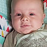 Gideon joined the competition — help win amazing prizes! baby, blanket, cheeks, child, closeup, colorful, cute, expression, face, head, indoors, infant, lying_down, onesie, pattern, person, portrait, skin, soft_light, young
