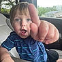 Kaiser is registered to the contest to win money with this photo: child, toddler, car_seat, blue_eyes, striped_shirt, hand, fingers, curious, indoor, car_interior, window, nature_outside, seat, young_child, person, portrait, expression, casual_clothing, skin, hair
