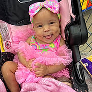 Jayella joined the competition — help win amazing prizes! baby, child, girl, pink_dress, headband, stroller, blanket, shopping_cart, smiling, tongue_out, cute, infant, clothing, person, indoor, face, hand, foot, fabric, colorful