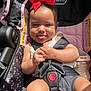 Jayella is registered to the contest to win money with this photo: baby, car_seat, red_bow, smiling, tongue_out, sunlight, bottle, white_tank_top, black_straps, child, infant, seatbelt, cute, happy, indoors, person, small_hands, shorts, pink, black