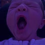 baby, yawning, close_up, face, mouth_open, infant, sleepy, indoors, purple_light, white_clothing, child, portrait, expression, head, person, newborn, cozy, dim_light, soft_focus, sleepiness