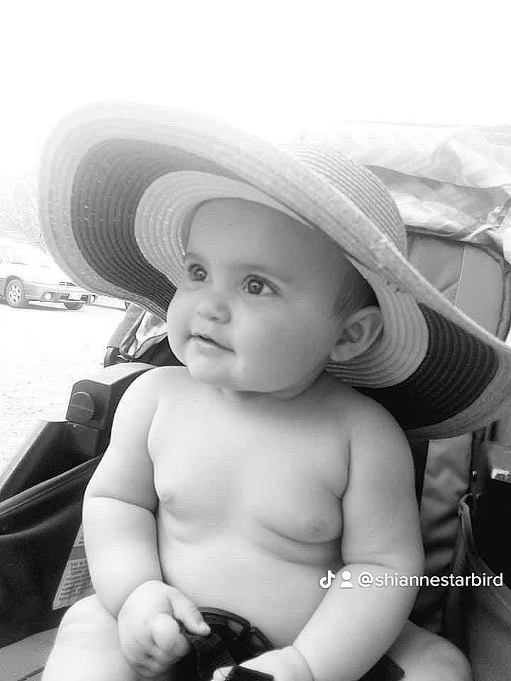 Ann is registered to the contest to win money with this photo: arm, baby, black, black_and_white, cap, face, facial_expression, flash_photography, gesture, hand, happy, hat, headwear, iris, lip, person, photograph, skin, smile, standing