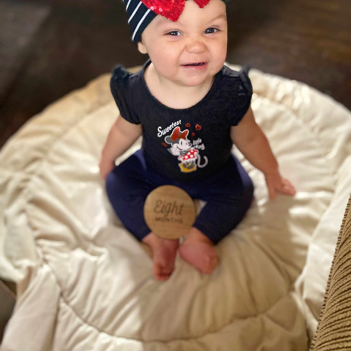 Reamonnee joined the competition — help win amazing prizes! baby, infant, child, headband, red_bow, sequins, navy_outfit, minnie_mouse, wooden_sign, eight_months, blanket, soft, cute, smiling, sitting, indoors, floor, playful_expression, portrait, young_child