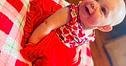 Reamonnee joined the competition — help win amazing prizes! baby, child, smiling, red_clothing, heart_pattern, blanket, checkered, indoor, floor, happy, cute, infant, portrait, sitting, skin, foot, head, face, person, cozy