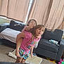box, carpet, child, children, clothing, couch, curtains, family, footwear, fun, home, indoor, living_room, person, piggyback, playful, shorts, toy, tshirt, window