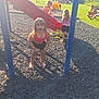 child, children, playground, slide, park, grass, sunlight, shadow, bench, adult, tree, outdoor, summer, play, barefoot, shorts, pink_top, red_slide, fun, daytime