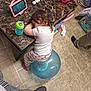 Violet is registered to the contest to win money with this photo: ball, bucket, chair, child, floor, footwear, household, indoor, marble_texture, pajamas, person, pink, resting, sippy_cup, sleeping, table, tablet, tile_floor, toddler, toy