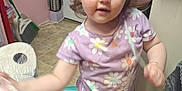 Violet joined the competition — help win amazing prizes! bag, barefoot, broom, cabinet, child, curly_hair, door, floor_tiles, floral_pattern, food_stains, indoor, kitchen, messy, person, plastic_wrap, purple_shirt, toddler, toilet_paper, water_bottles, young_child