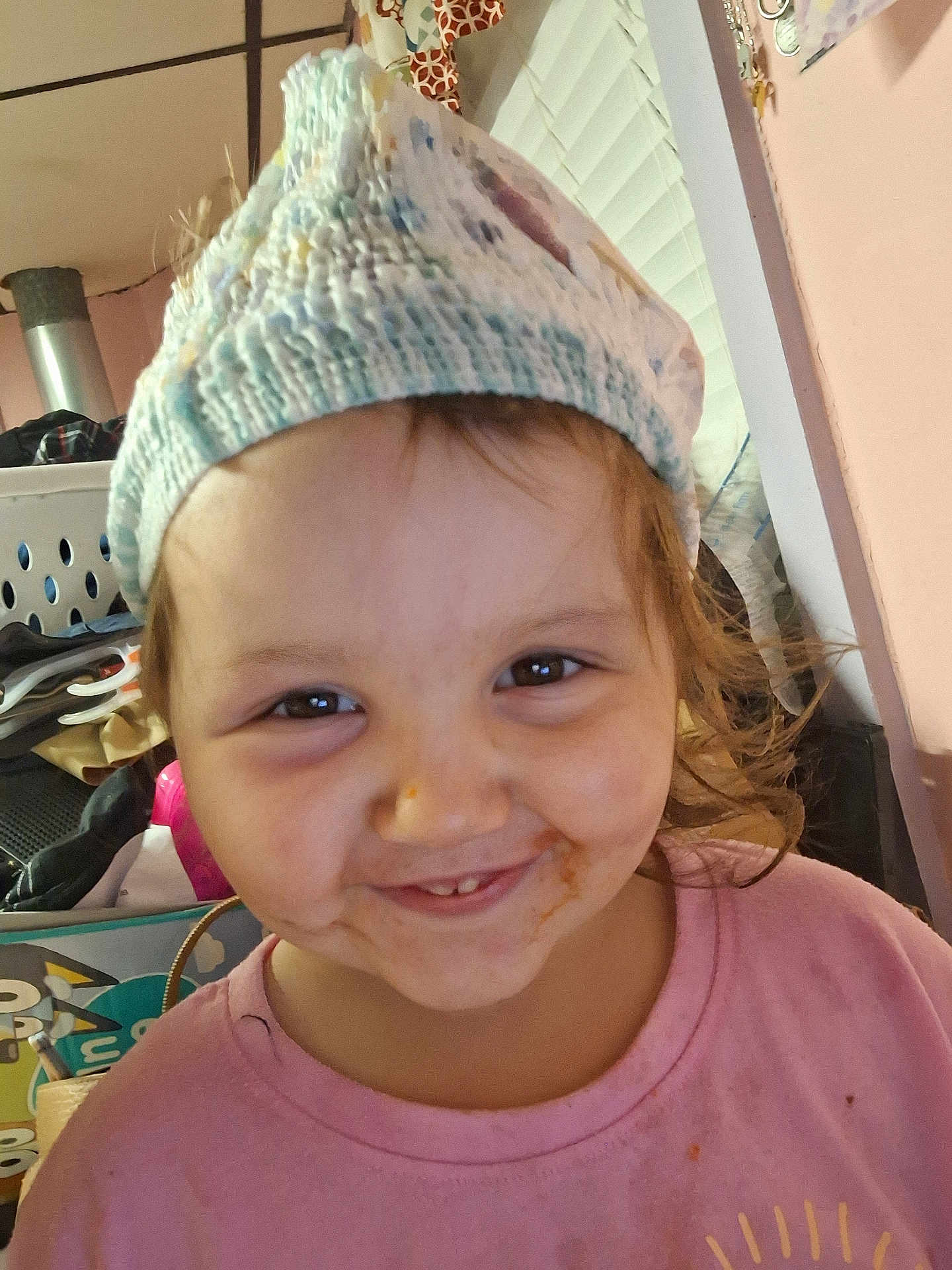 Violet joined the competition — help win amazing prizes! child, smiling, face, hat, knitted_hat, messy_face, indoor, clothing, pink_shirt, young_child, person, portrait, cute, happy, brown_eyes, hair, closeup, expression, home, cozy