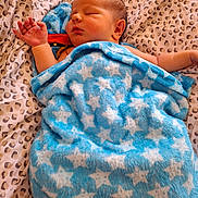 Altris joined the competition — help win amazing prizes! newborn, baby, blanket, blue, stars, sleeping, infant, bedspread, leopard_print, soft, cute, peaceful, resting, child, wrapped, cozy, face, skin, head, hand