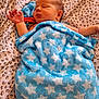 newborn, baby, blanket, blue, stars, sleeping, infant, bedspread, leopard_print, soft, cute, peaceful, resting, child, wrapped, cozy, face, skin, head, hand
