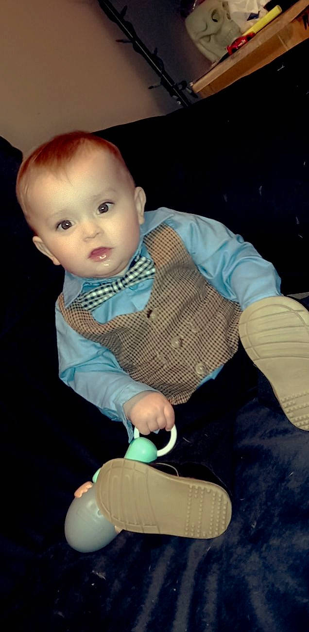 David is registered to the contest to win money with this photo: baby, baby_products, baby_toddler_clothing, cheek, child, comfort, electric_blue, facial_expression, finger, flooring, fun, hairstyle, human_leg, joint, lap, person, sitting, skin, sleeve, thumb