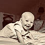 baby, smiling, crawling, bed, indoor, child, cute, happiness, portrait, infant, room, lamp, toy_car, striped_wallpaper, blanket, clothing, face, person, home, cozy