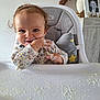 baby, high_chair, food, messy, smiling, face, hand, clothing, cushion, home, table, portrait, child, cute, indoor, person, feeding, happy, hair, seat