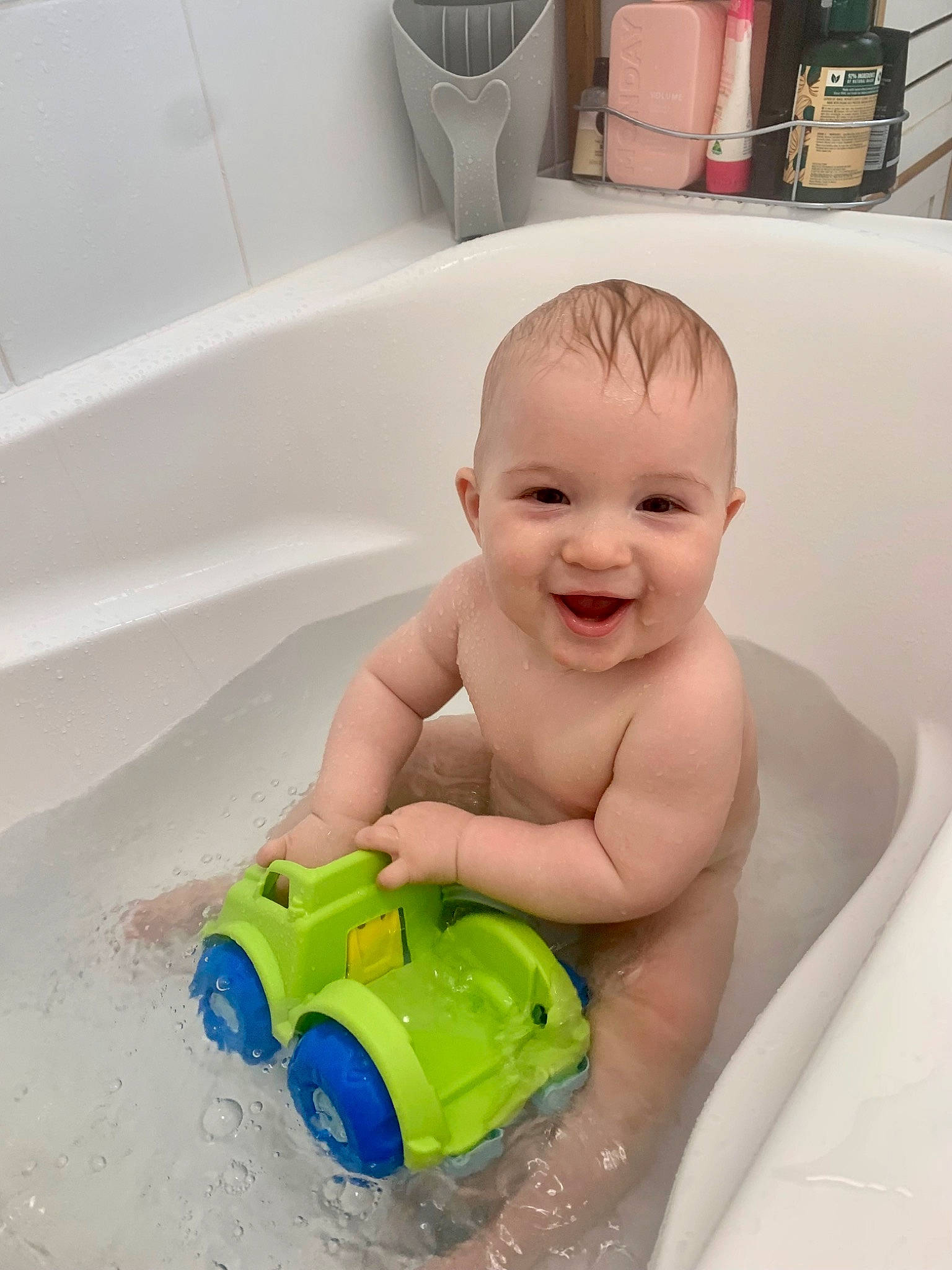 Dean is registered to the contest to win money with this photo: baby, baby_bathing, baby_playing_with_toys, baby_products, bath_toy, bathing, bathroom, bathtub, child, flooring, fun, happy, joy, leisure, person, product, skin, smile, toddler, toy