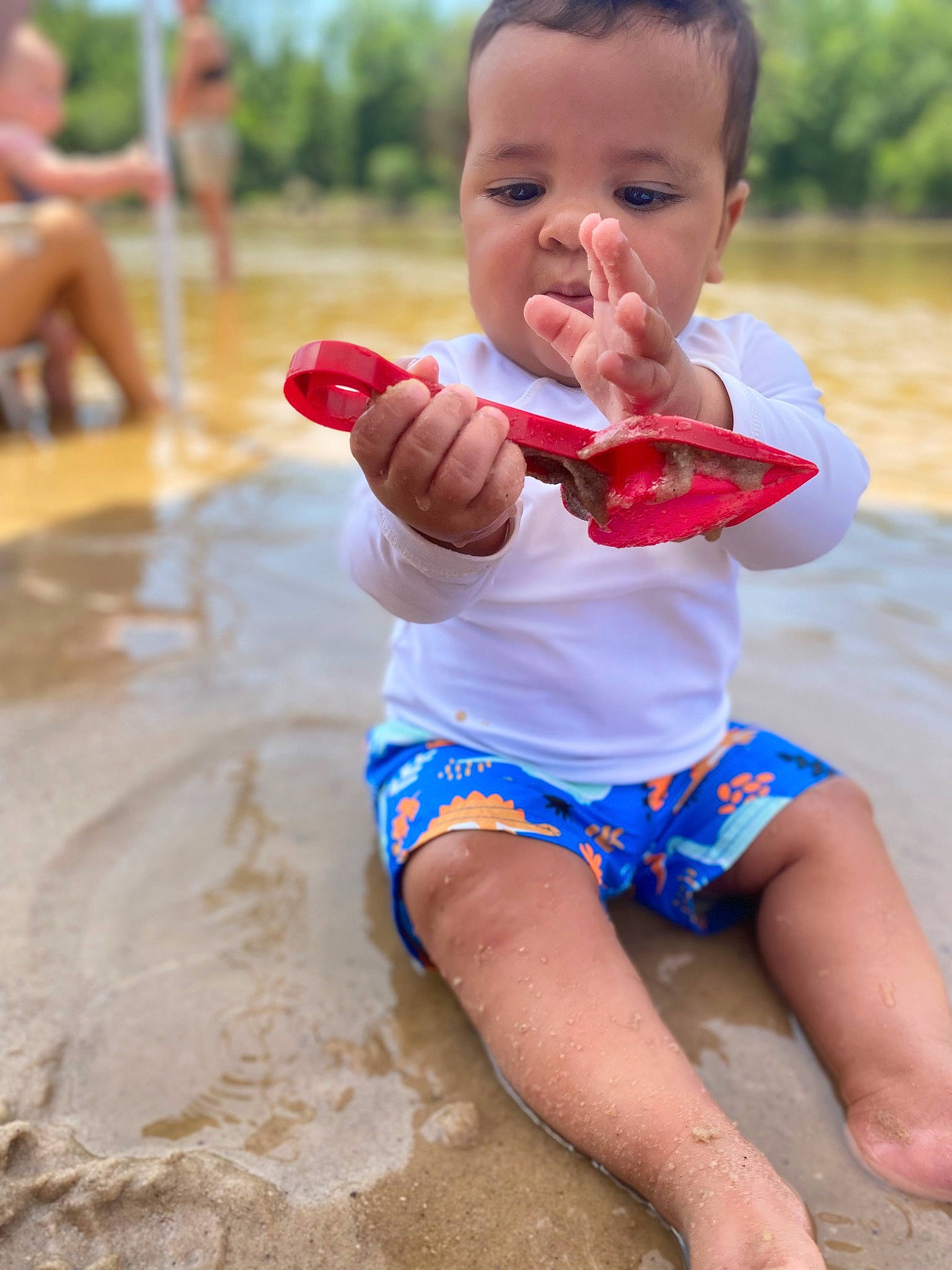 Karson is registered to the contest to win money with this photo: baby, baby_toddler_clothing, beach, child, finger, fun, happy, leisure, people_in_nature, people_on_beach, person, play, recreation, sand, shorts, sitting, sky, summer, thigh, toddler