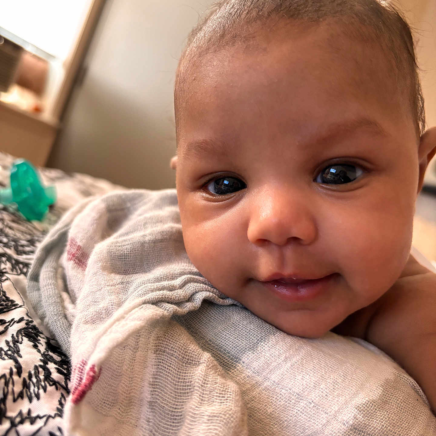 Mulahn joined the competition — help win amazing prizes! baby, infant, closeup, face, eyes, smile, blanket, soft, indoors, cute, skin, head, person, child, newborn, lying_down, expression, warm, cozy, portrait