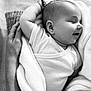 baby, infant, sleeping, blanket, hand, black_and_white, soft_texture, peaceful, close_up, cuddle, newborn, smile, person, skin, comfort, rest, portrait, gentle, love, tenderness