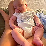 Noé participe au concours pour gagner de l'argent avec cette photo : baby, sleeping, infant, onesie, whale, adult, legs, hand, skin, indoors, couch, relaxation, peaceful, soft_lighting, closeup, child, nap, cute, person, resting