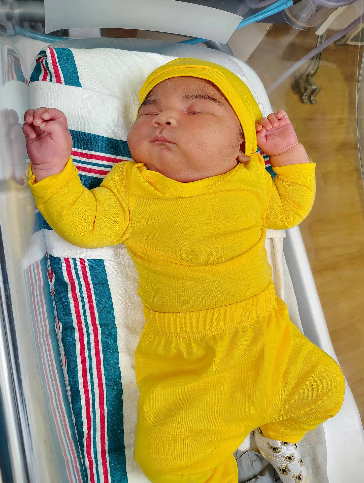Yeshua Mk is registered to the contest to win money with this photo: baby, bassinet, blanket, child, cute, headwear, hospital, human, indoors, infant, newborn, peaceful, person, resting, sleeping, small, sock, soft, toddler, yellow_clothing