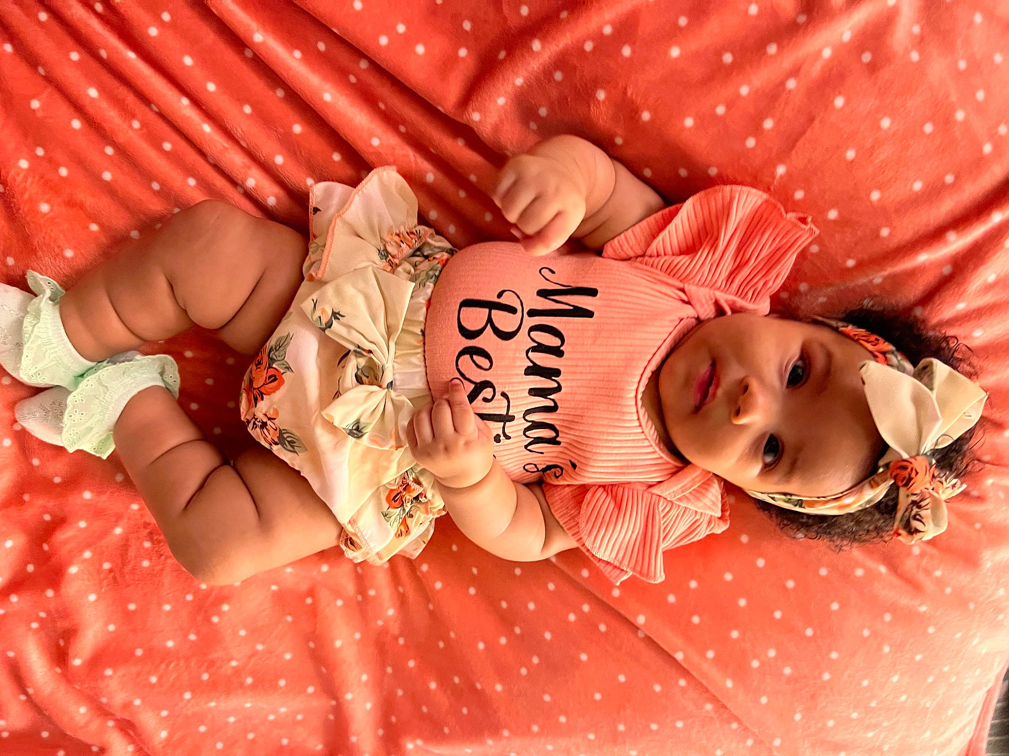 Mikayla joined the competition — help win amazing prizes! arm, baby, baby_toddler_clothing, eyelash, finger, hand, happy, human, human_body, mouth, muscle, orange, person, pink, plant, product, skin, stomach, textile, thigh