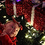 baby, infant, holiday, christmas, lights, decoration, red_clothing, bow, face, headband, toddler, festive, glowing, indoors, celebration, cute, smiling, cozy, sparkly, background