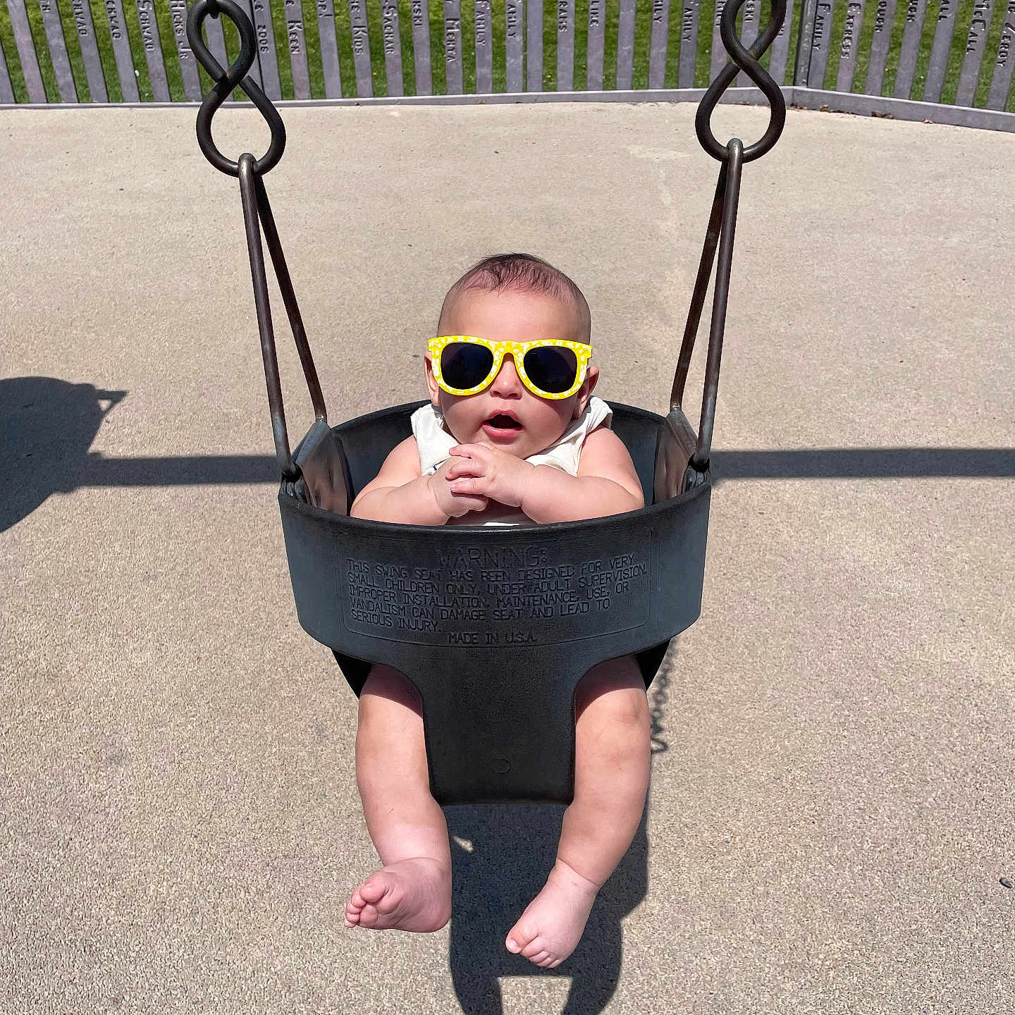 Koda Blu joined the competition — help win amazing prizes! baby, bucket_swing, child, concrete, cool, cute, feet, fun, grass, infant, legs, metal_chain, outdoor, park, playground, shadow, summer, sunglasses, sunny, swing
