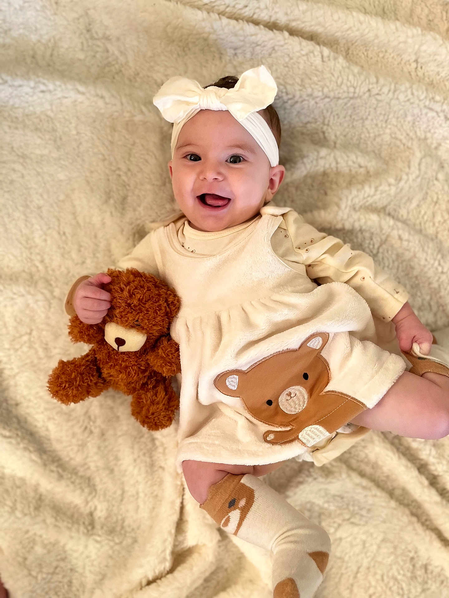 Taelynn joined the competition — help win amazing prizes! baby, child, smiling, teddy_bear, headband, dress, bear_design, blanket, soft_texture, cute, happy, infant, lying_down, playful, cozy, sock, fabric, person, portrait, indoors