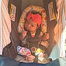baby, car_seat, infant, headband, colorful_clothing, safety_harness, seatbelt, indoors, child, cute, sunlight, pink, patterned_pillow, newborn, foot, hand, face, person, resting, seat
