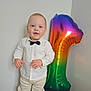 Vladian a rejoint le concours — aidez-le/la à gagner de superbes lots ! toddler, child, balloon, number_one, bow_tie, white_shirt, pants, socks, standing, indoor, celebration, party, floor, wall, smile, happy, portrait, cute, colorful, birthday