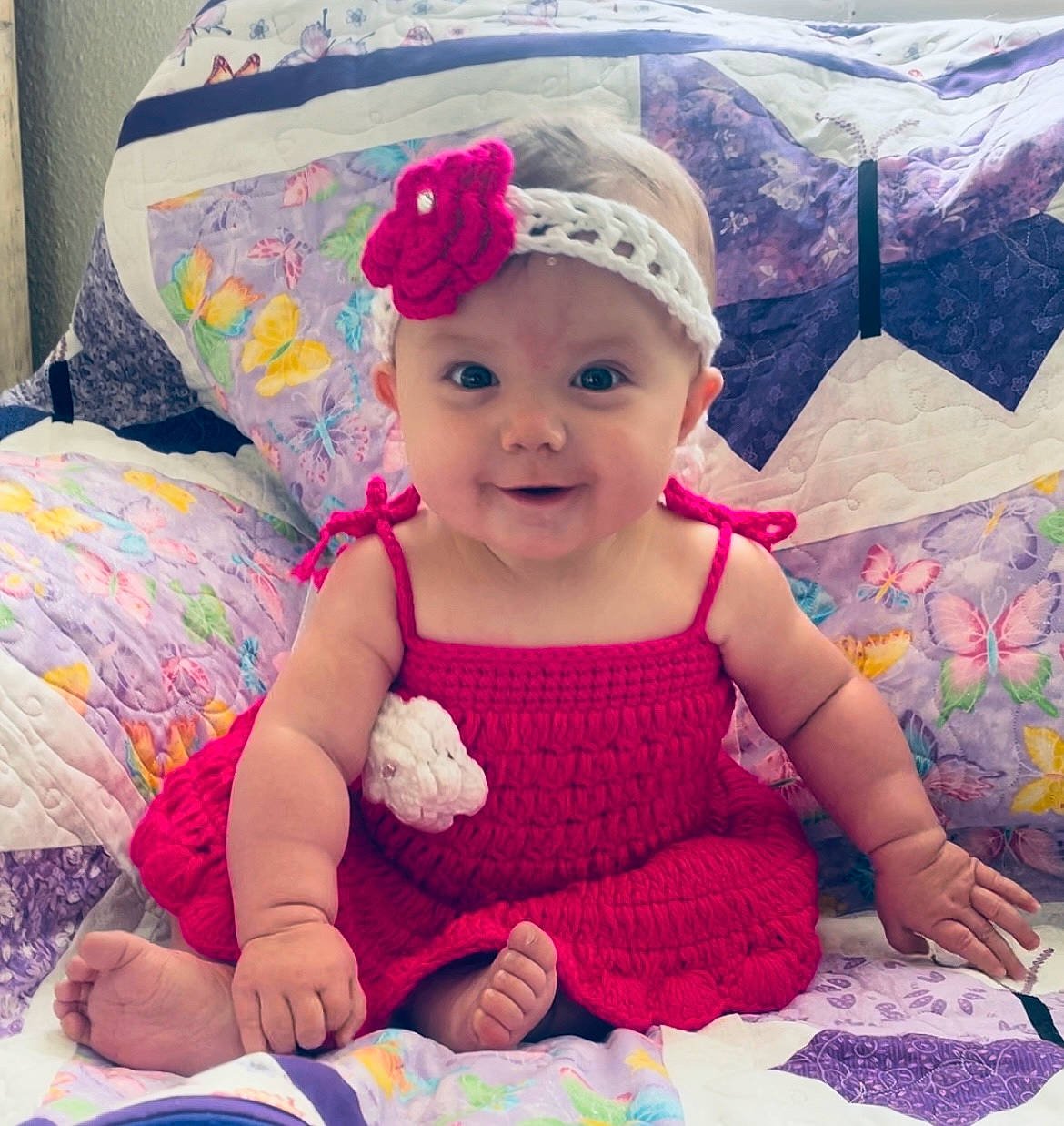 Ember is registered to the contest to win money with this photo: baby, baby_toddler_clothing, beauty, cap, child, comfort, cool, eye, happy, head, headwear, joy, pattern, person, pink, product, purple, skin, sleeve, smile