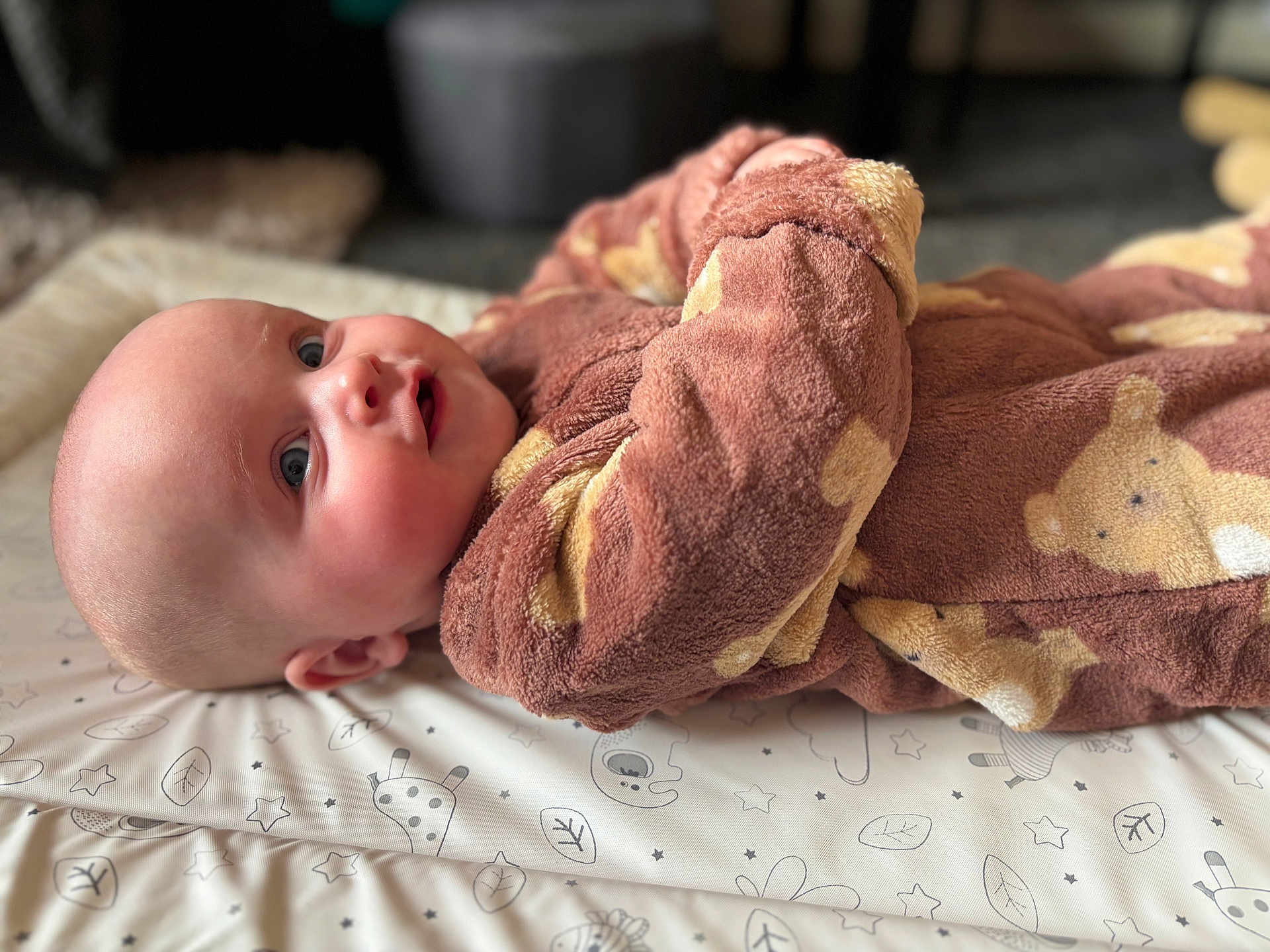 Mabel-Lilly joined the competition — help win amazing prizes! baby, child, infant, onesie, teddy_bear_prints, cozy, lying_down, blue_eyes, soft_skin, patterned_mat, cute, smiling, indoors, portrait, young, head, face, clothing, baby_garment, resting
