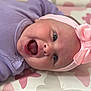 Mabel-Lilly is registered to the contest to win money with this photo: baby, infant, smiling, headband, pink_bow, purple_clothing, lying_down, blanket, pattern, butterfly, happy, cute, face, tongue_out, closeup, child, soft_lighting, portrait, indoors, person