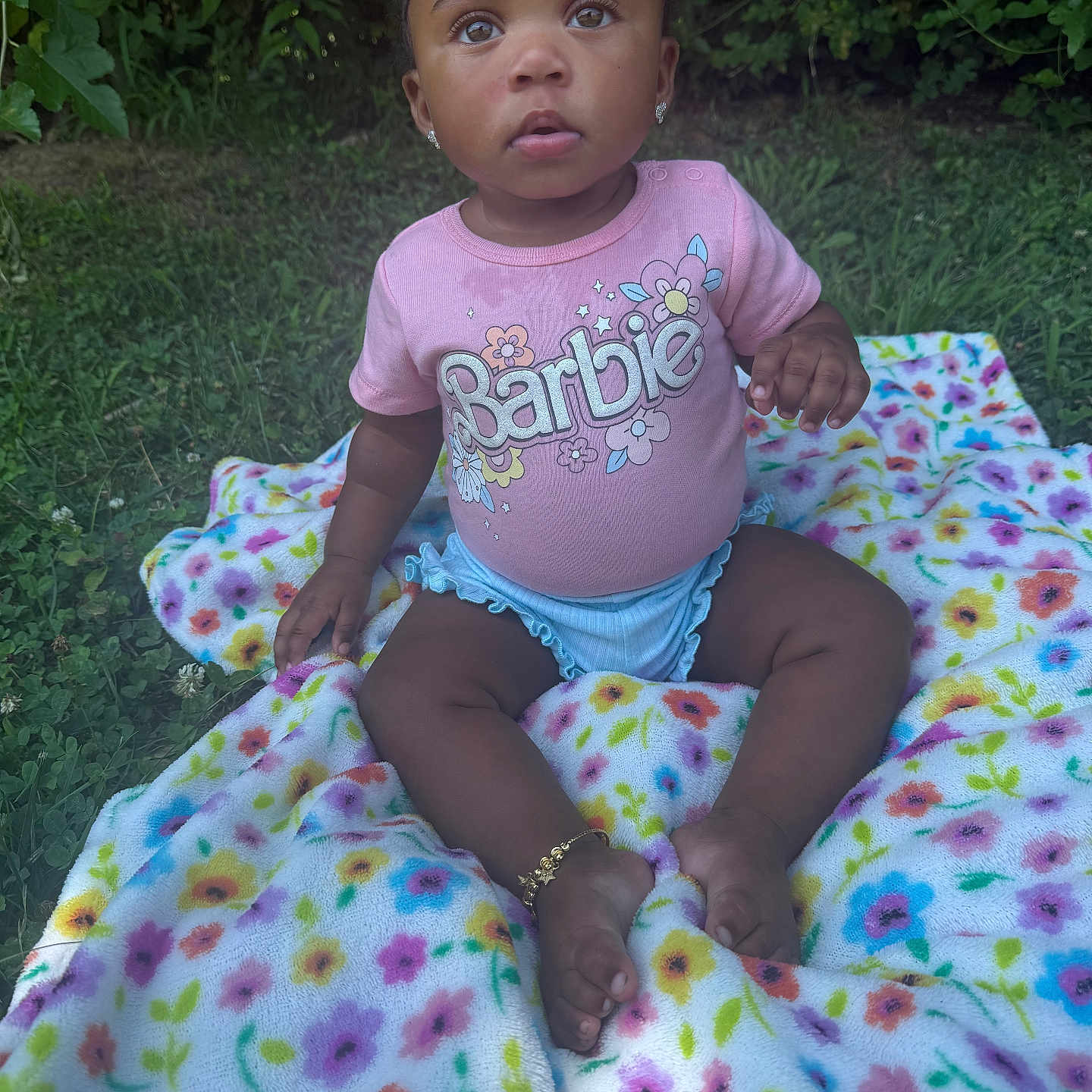 Serenity is registered to the contest to win money with this photo: baby, barbie, blanket, bracelet, child, curious, cute, earrings, flower_pattern, grass, grass_background, innocent, nature, outdoor, pink_shirt, portrait, sitting, summer, toddler, young_child