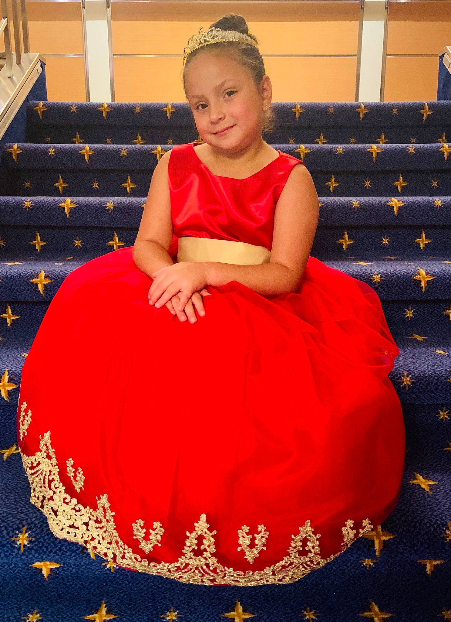 Lexi is registered to the contest to win money with this photo: child, costume, dress, joy, person, red, sitting, tradition