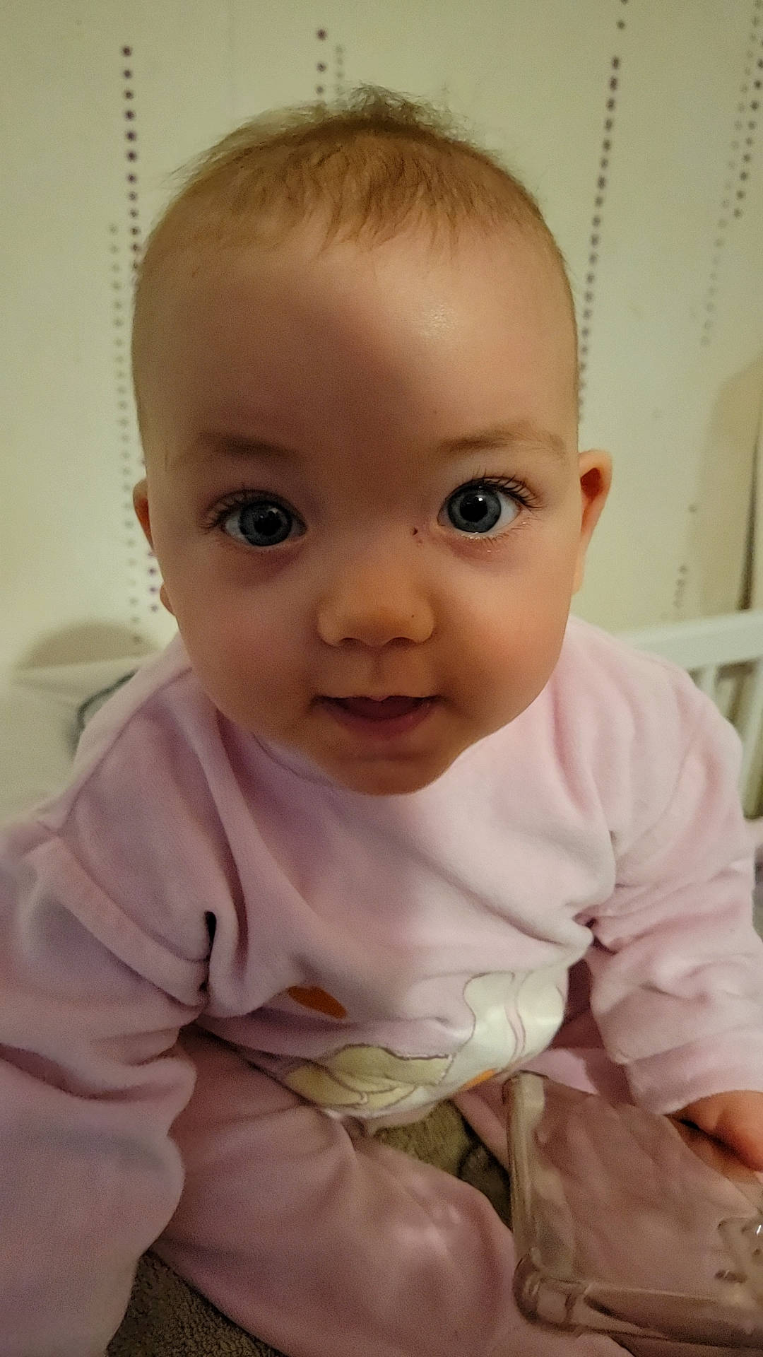 Lyna participe au concours pour gagner de l'argent avec cette photo : baby, baby_toddler_clothing, cheek, child, chin, comfort, eye, eyebrow, eyelash, flooring, iris, linens, lip, nose, person, sitting, skin, sleeve, smile, toddler