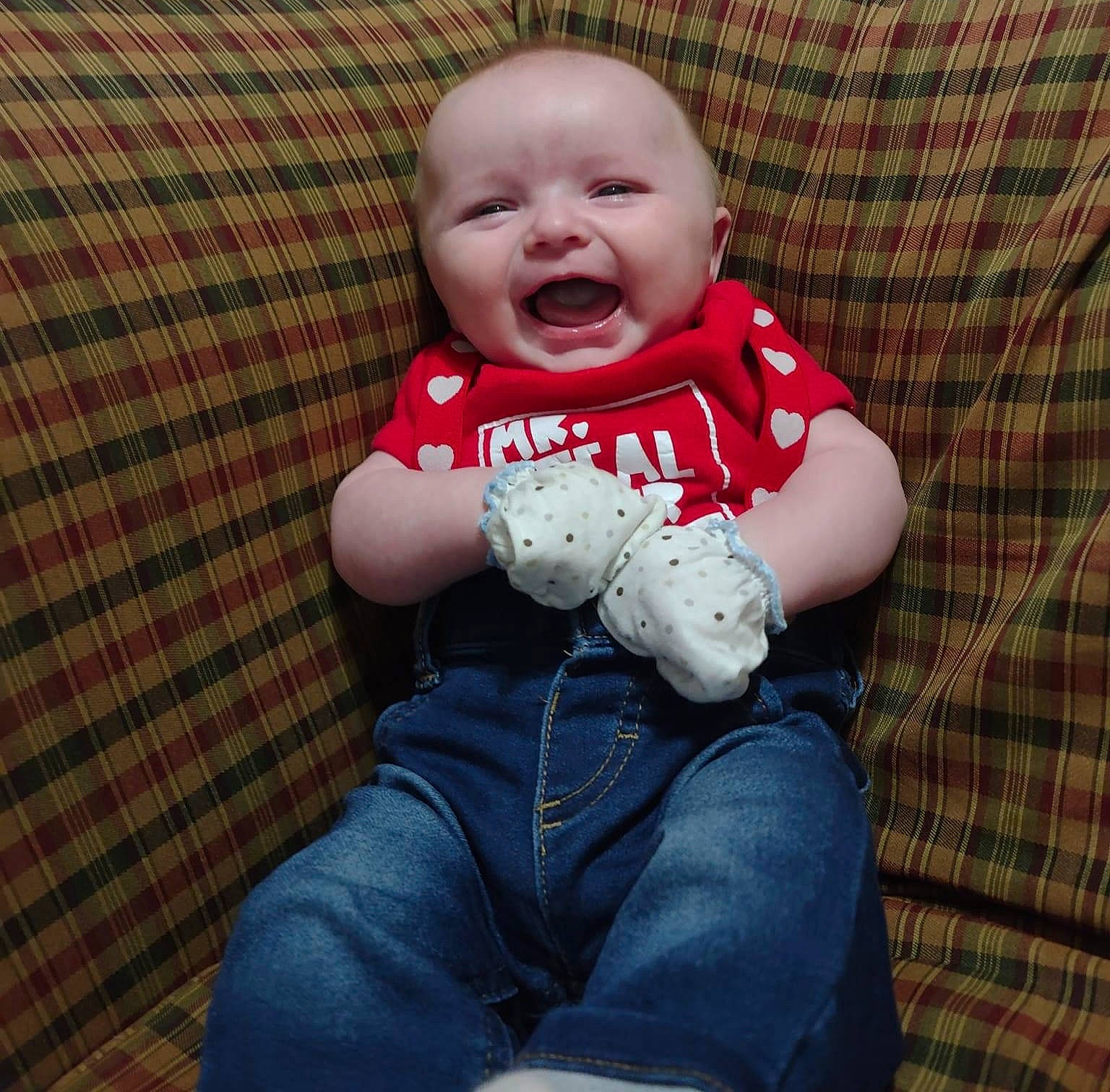 Collin is registered to the contest to win money with this photo: baby, baby_toddler_clothing, cheek, comfort, denim, eye, finger, flooring, happy, head, jeans, pattern, person, plaid, skin, sleeve, smile, t_shirt, tartan, textile