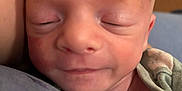 James is registered to the contest to win money with this photo: baby, newborn, sleeping, close_up, face, skin, infant, clothing, button, soft, peaceful, cute, child, portrait, resting, human, head, small, delicate, newborn_baby
