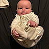 James joined the competition — help win amazing prizes! baby, infant, pajamas, cute, face, hands, feet, tongue, lying_down, black_background, child, newborn, person, skin, sleepwear, expression, closeup, adorable, young, playful