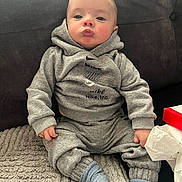 Casper joined the competition — help win amazing prizes! baby, child, toddler, grey_clothing, hoodie, socks, sitting, blanket, couch, indoor, face, expression, pouting, nike, casual, cute, young, person, portrait, cozy
