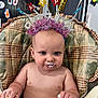 baby, birthday, blue_eyes, cake, celebration, child, cute, decorations, face, food, frosting, hands, headband, high_chair, indoors, messy, party, plaid, smudge, toddler